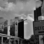 Picture of Detour sign with city buildings in the background